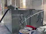Dinosaw machine showing Multiple materials arranged in parallel, capable of cutting up to 9 tombstones at once.